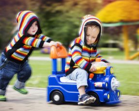 車の玩具に乗ってる子供（加工後）